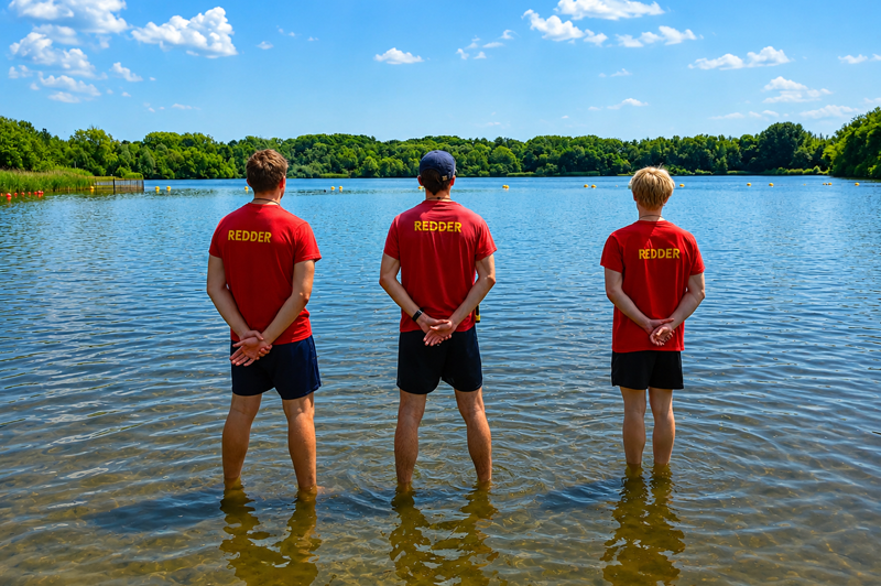 Three lifeguards monitoring the supervised swimming area at De Plas beach in Rotselaar